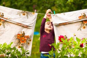 Funny little girl with the clothesline